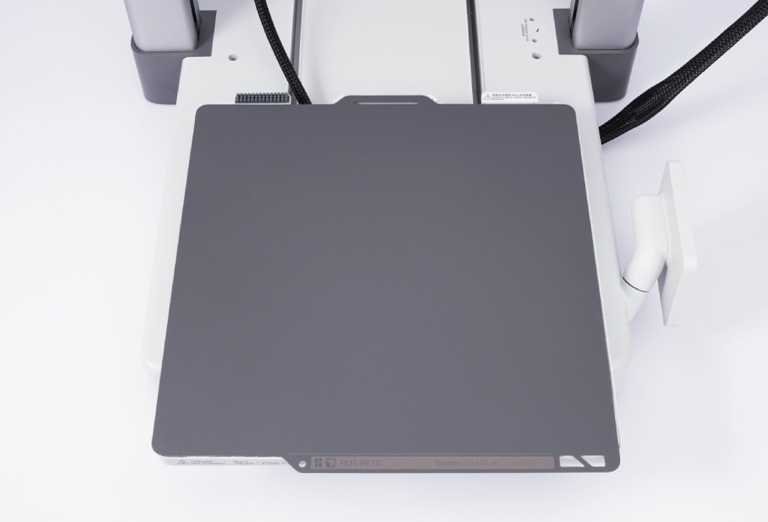 Другий крок встановлення: опускання та фіксація гнучкої пластини SuperTack на магнітній платформі принтера Bambu Lab