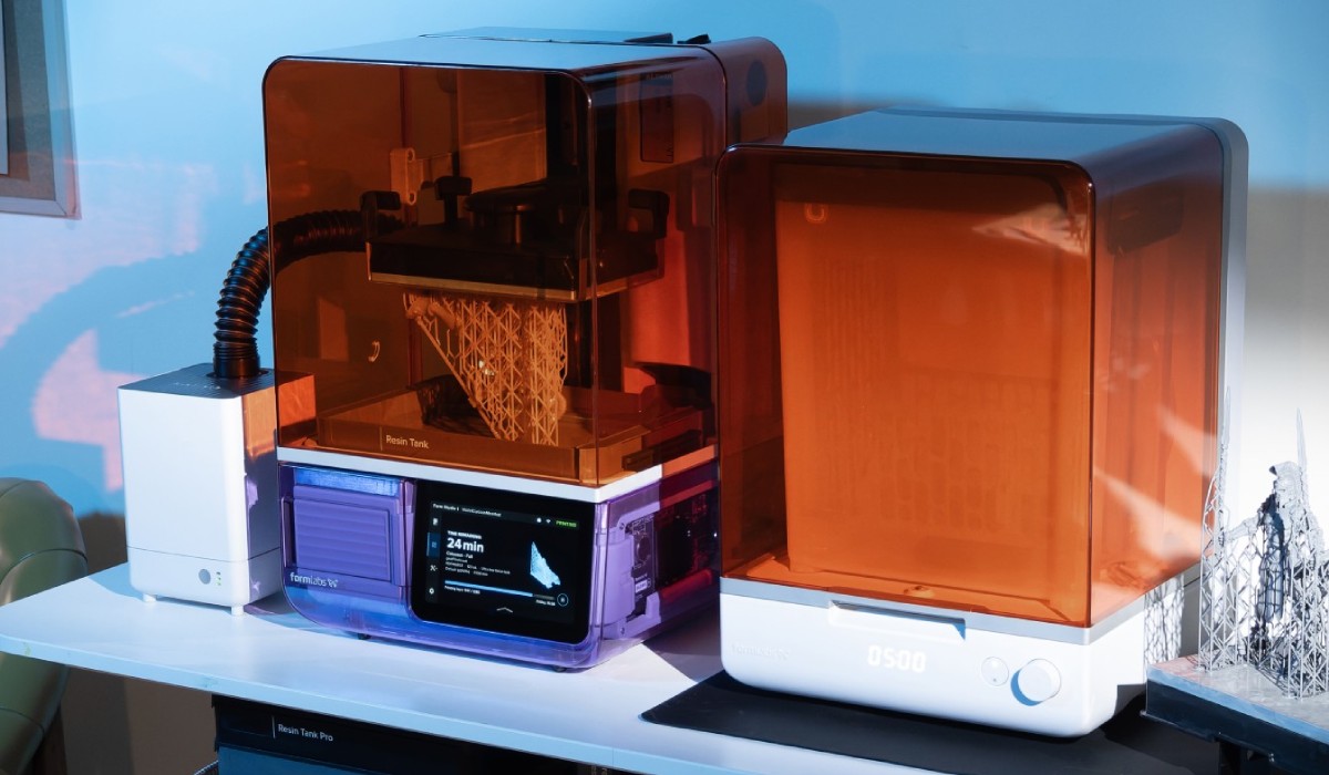 Formlabs VOC Extractor exhaust with flexible air hose next to Formlabs photopolymer 3D printer